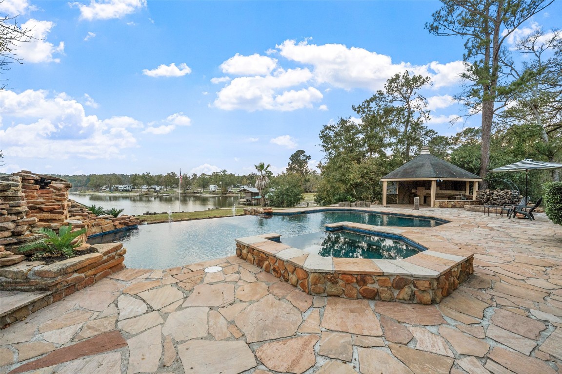 186 Lake Road Huntsville, TX 77320 - Photo 42 of 48 a view of a swimming pool with a lounge chairs
