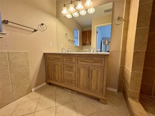 a spacious bathroom with a mirror and a shower