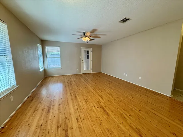 wooden floor in an empty room with a window