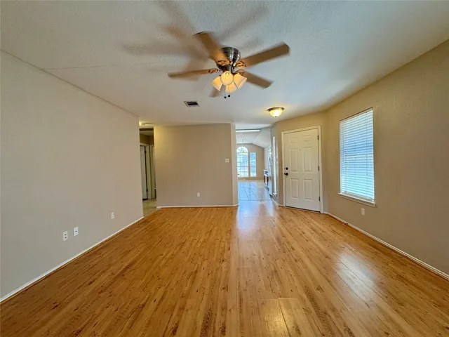 a view of a livingroom with a hardwood floor and a ceiling fan