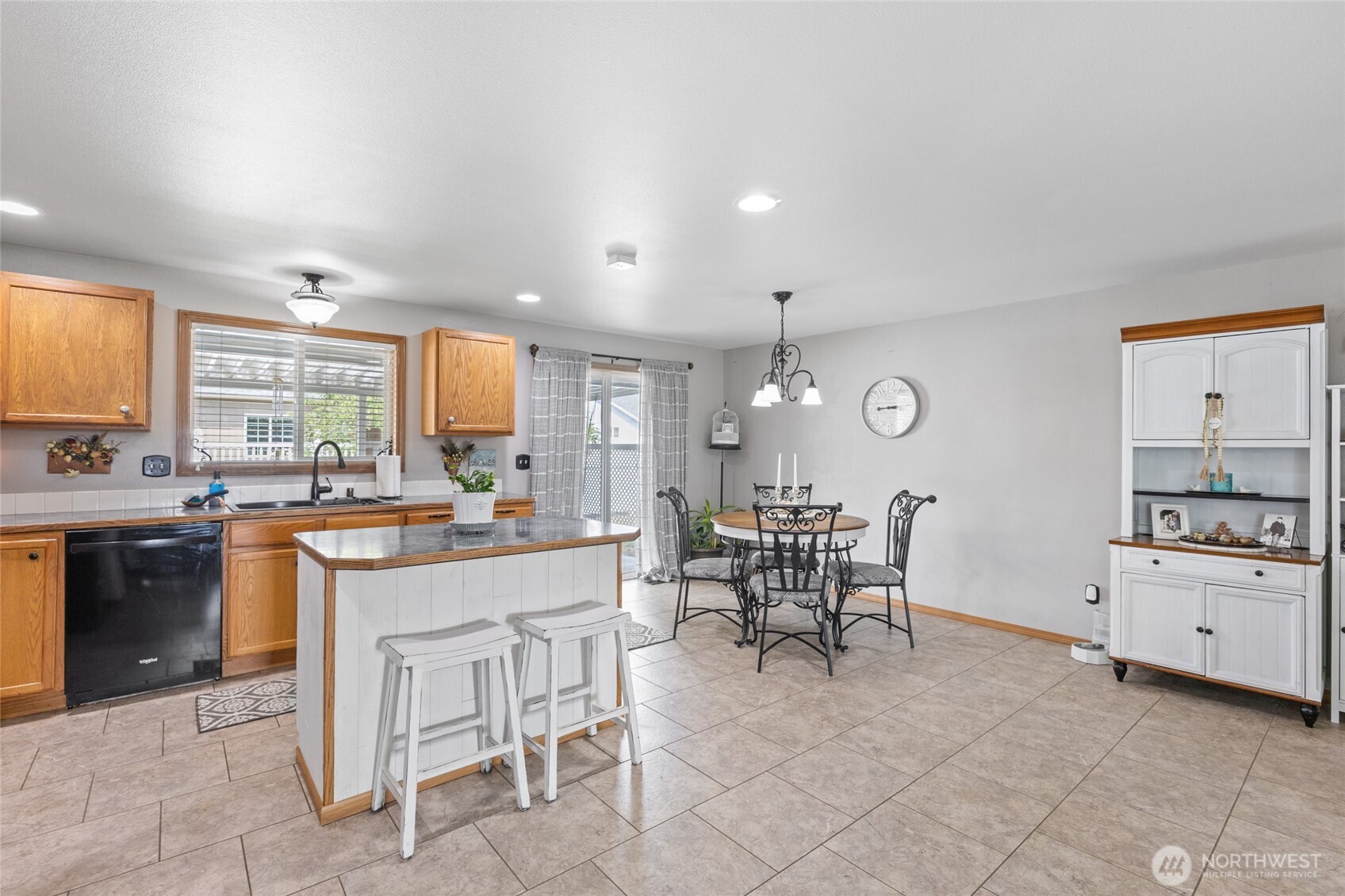1346 Greens Loop Moses Lake, WA 98837 - Photo 11 of 39 a kitchen with white cabinets and chairs