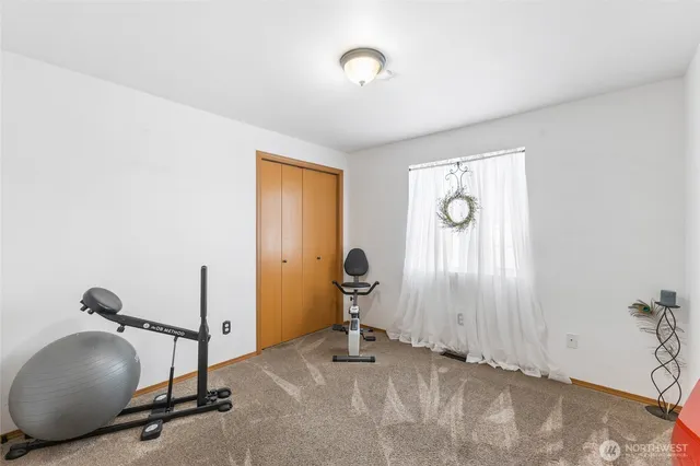 a room with gym equipment and a large mirror