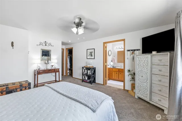 a bedroom with furniture and a flat screen tv