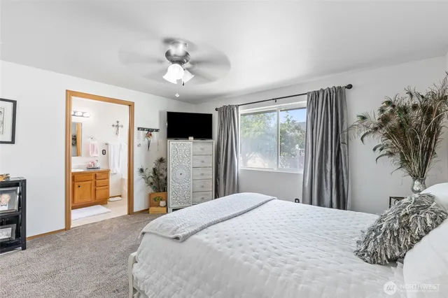 a bedroom with a large bed and a chandelier
