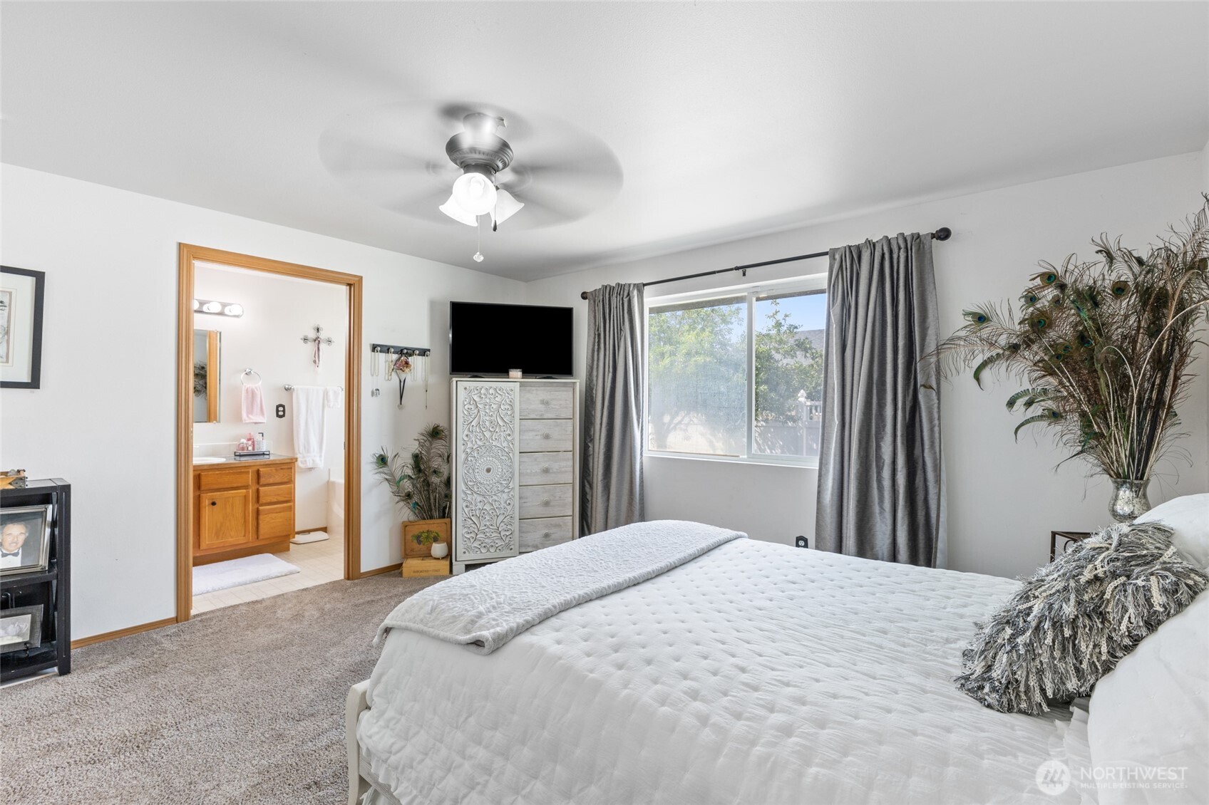 1346 Greens Loop Moses Lake, WA 98837 - Photo 25 of 39 a bedroom with a large bed and a chandelier