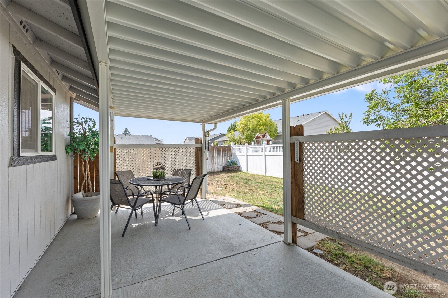 1346 Greens Loop Moses Lake, WA 98837 - Photo 28 of 39 a view of a patio with a table chairs and backyard