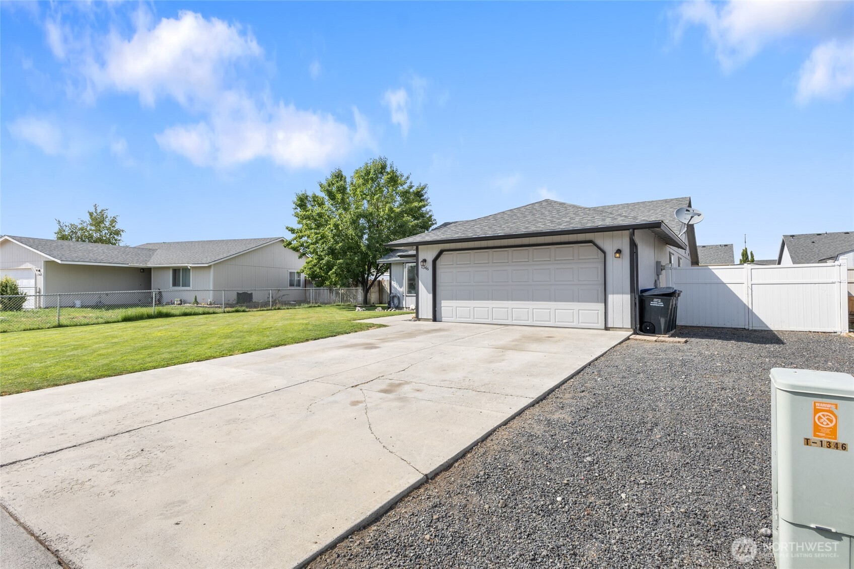 1346 Greens Loop Moses Lake, WA 98837 - Photo 33 of 39 a front view of a house with a yard and garage