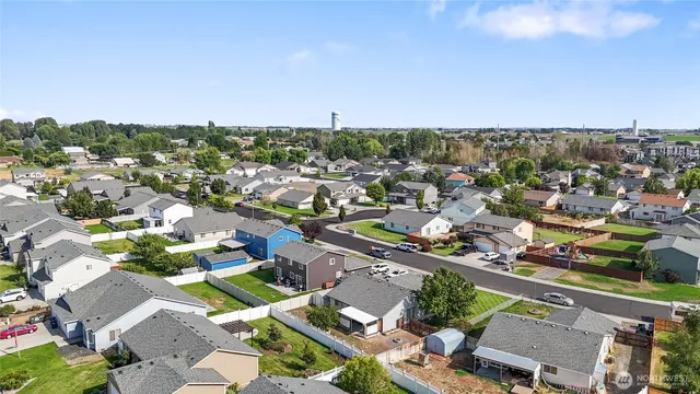 an aerial view of a houses with city view