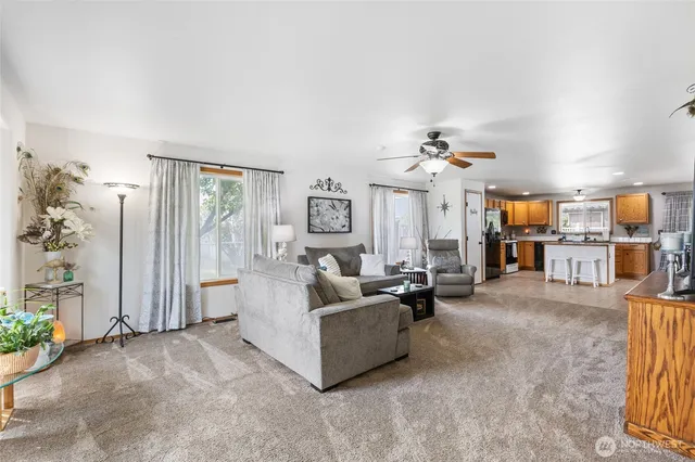 a living room with furniture and a chandelier