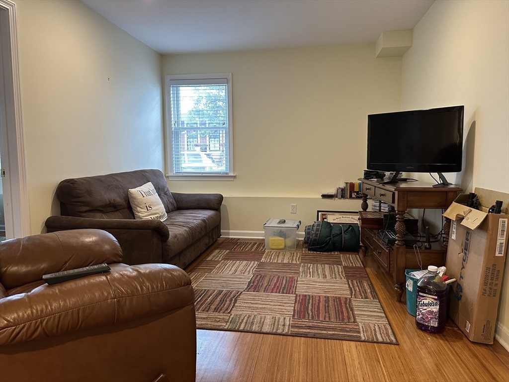 209 Adams Street, Unit B Malden, MA 02148 - Photo 11 of 30 a living room with furniture and a flat screen tv