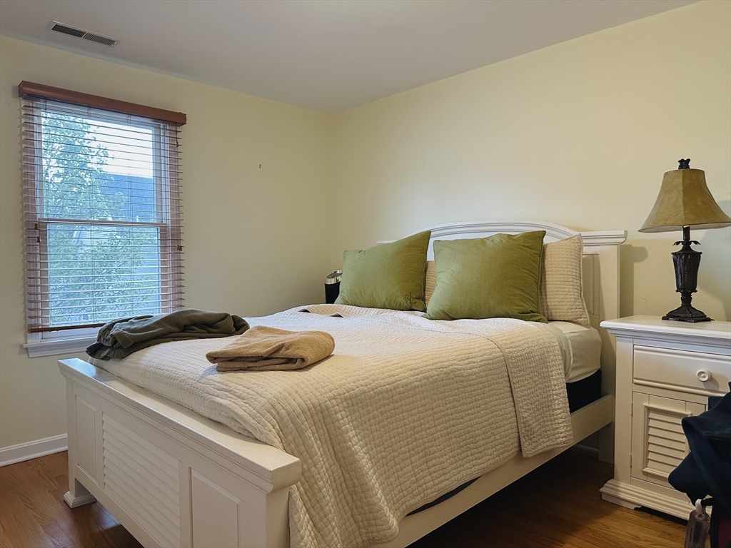 209 Adams Street, Unit B Malden, MA 02148 - Photo 16 of 30 a bedroom with a bed and two windows