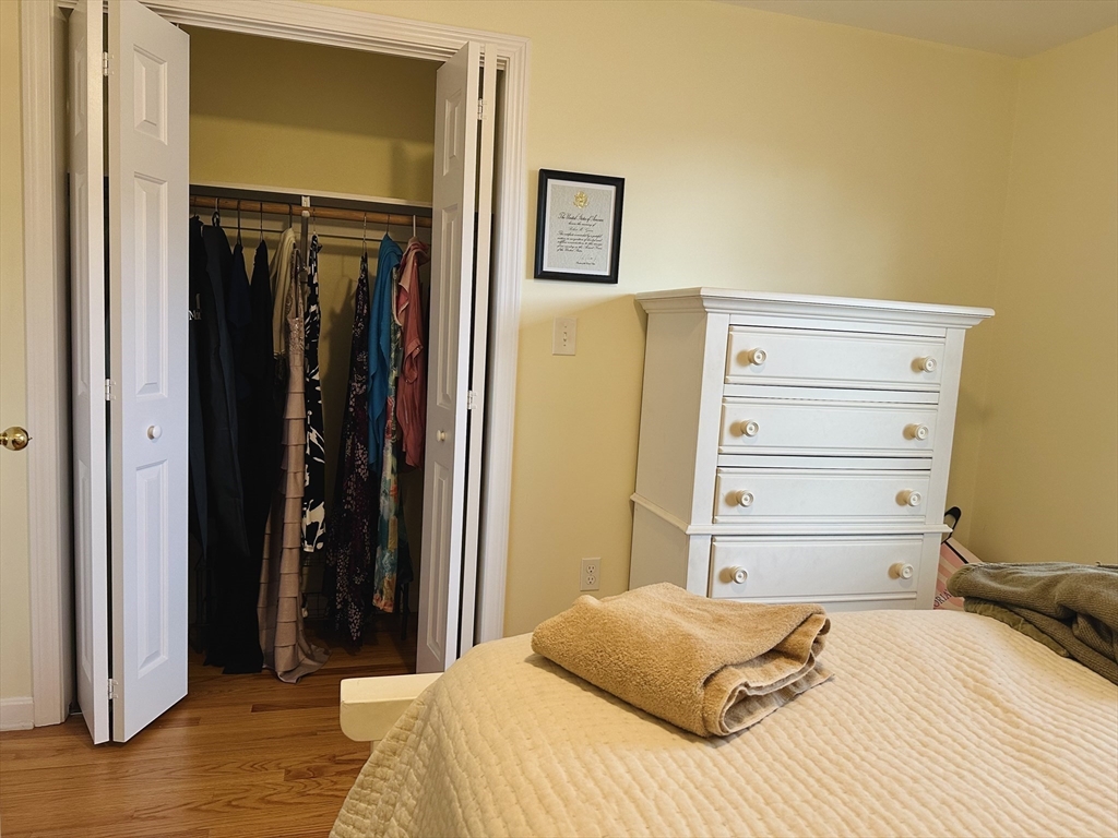 209 Adams Street, Unit B Malden, MA 02148 - Photo 17 of 30 a bedroom with a bed and a closet