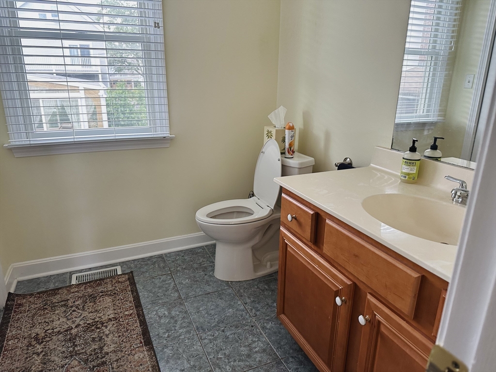 209 Adams Street, Unit B Malden, MA 02148 - Photo 18 of 30 a bathroom with a sink and a toilet