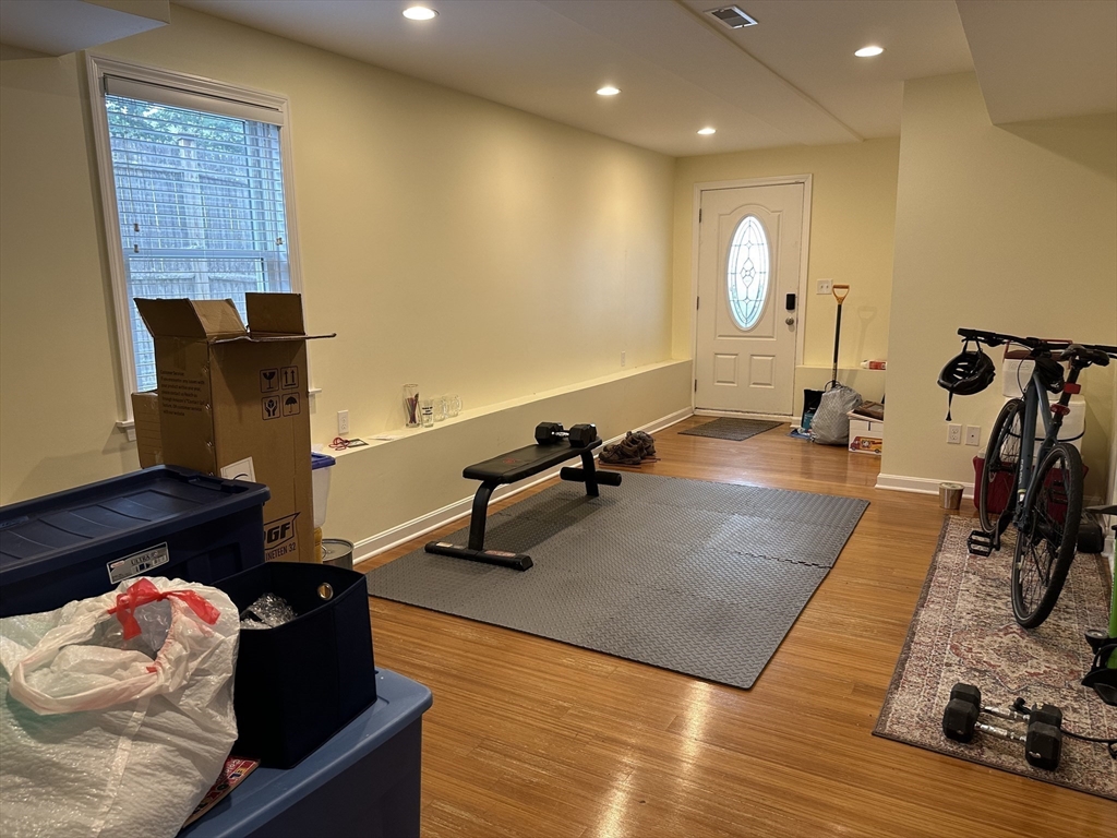 209 Adams Street, Unit B Malden, MA 02148 - Photo 23 of 30 a living room with gym equipment