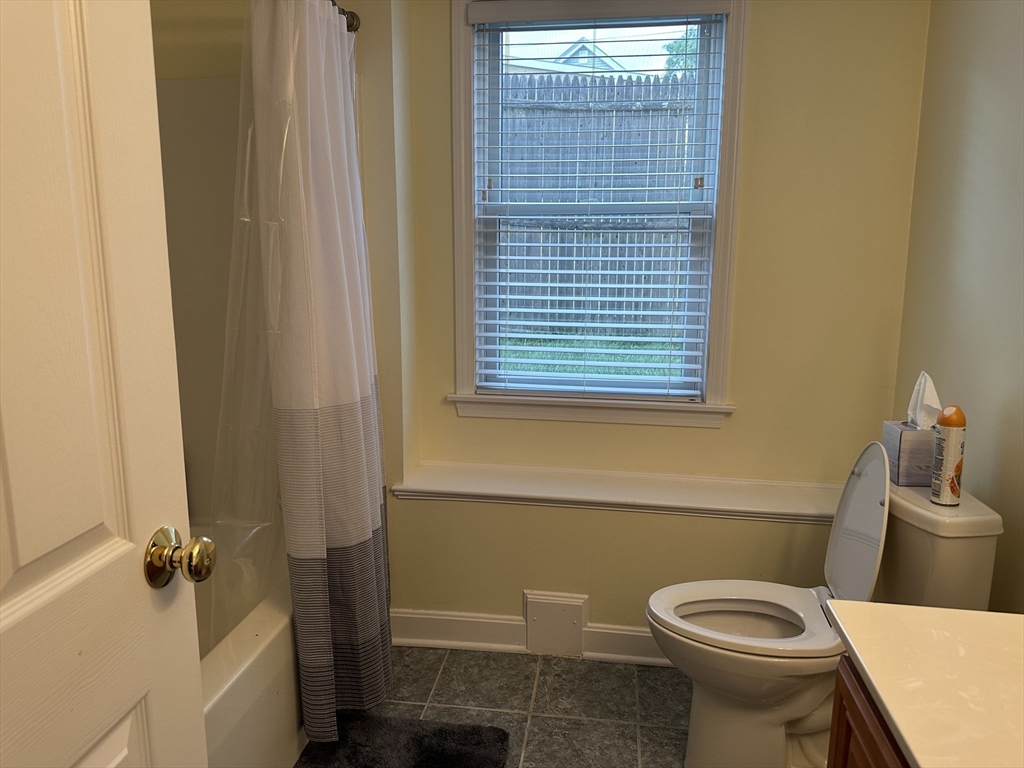 209 Adams Street, Unit B Malden, MA 02148 - Photo 26 of 30 a bathroom with a sink and toilet