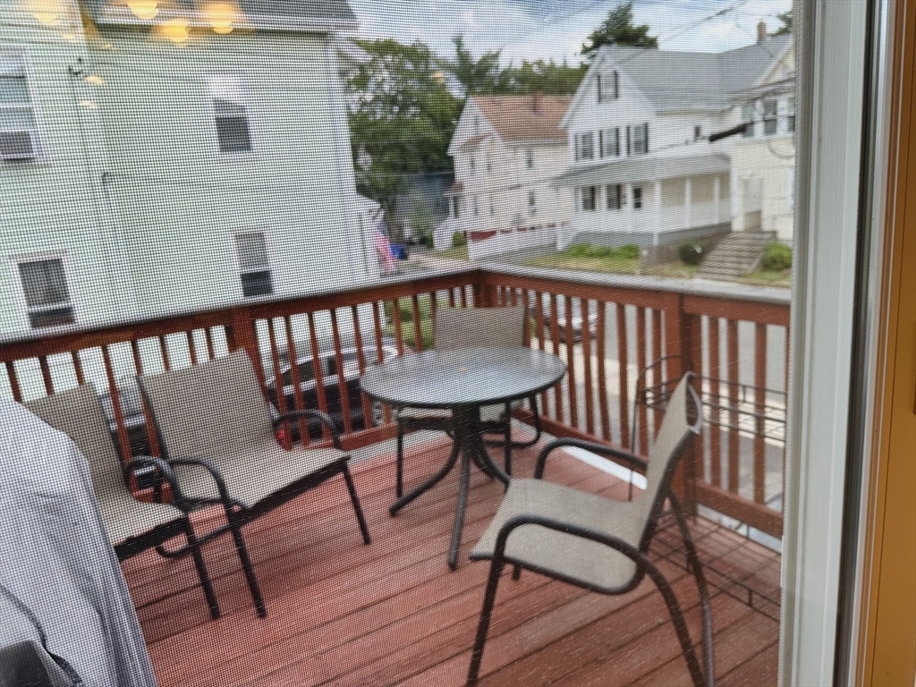 209 Adams Street, Unit B Malden, MA 02148 - Photo 27 of 30 a view of a chair and table in the balcony