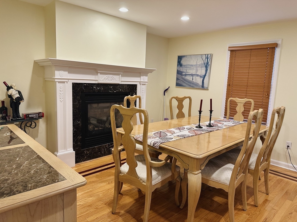 209 Adams Street, Unit B Malden, MA 02148 - Photo 5 of 30 a view of a dining room with furniture and a fireplace