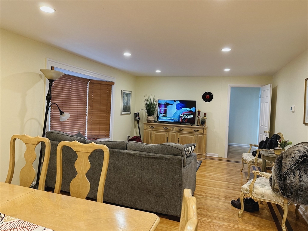 209 Adams Street, Unit B Malden, MA 02148 - Photo 6 of 30 a living room with furniture and a flat screen tv