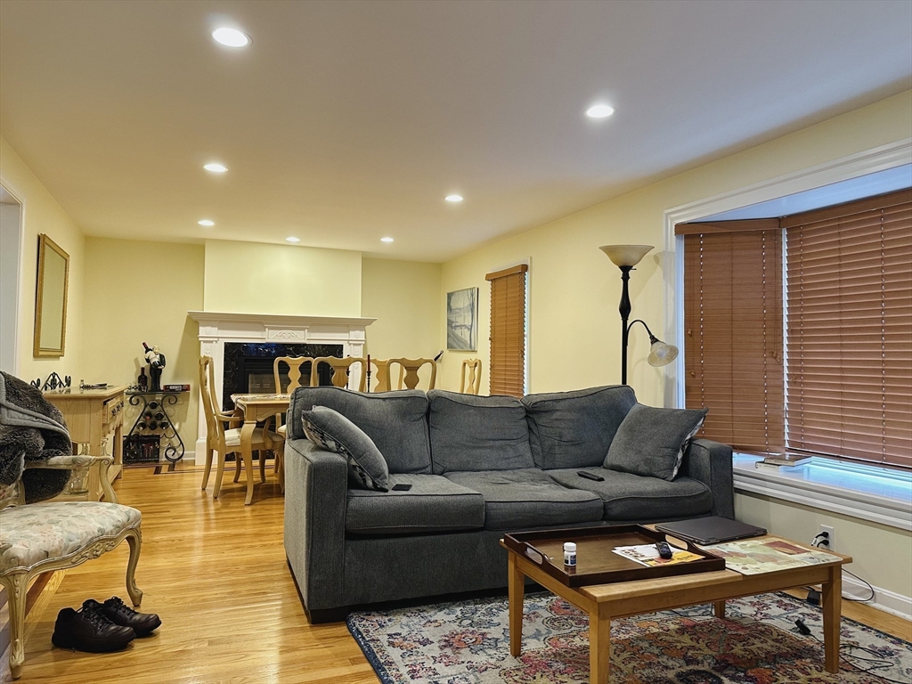 209 Adams Street, Unit B Malden, MA 02148 - Photo 8 of 30 a living room with furniture a couch and a fireplace