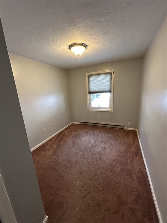 3 Hinman Street, Unit 2 Sturbridge, MA 01518 - Photo 5 of 9 an empty room with a window