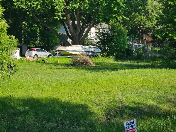 a childrens park with lots of green space and trees