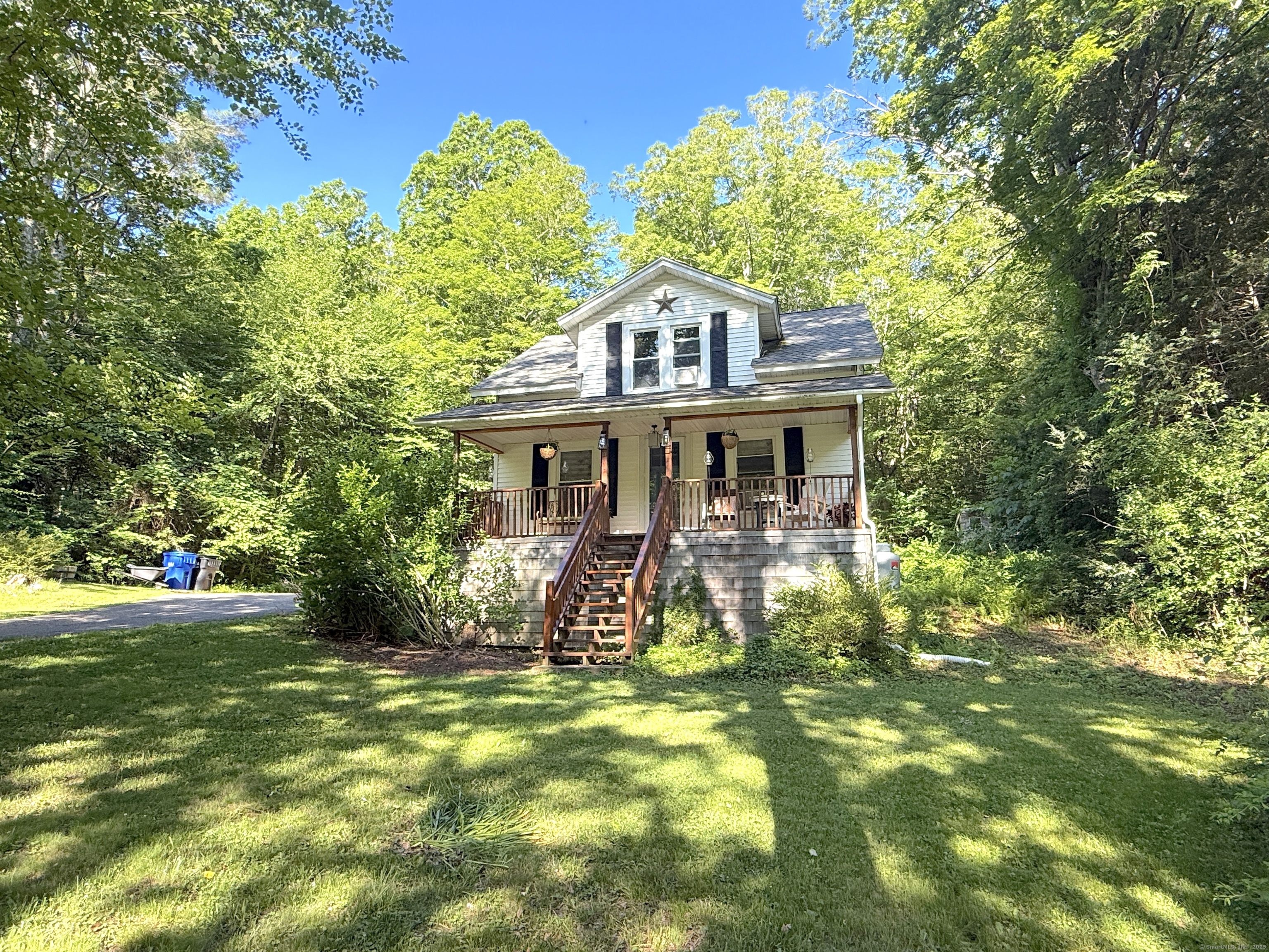 389 Colebrook River Road Colebrook, CT 06021 - Photo 1 of 1 a front view of a house with garden