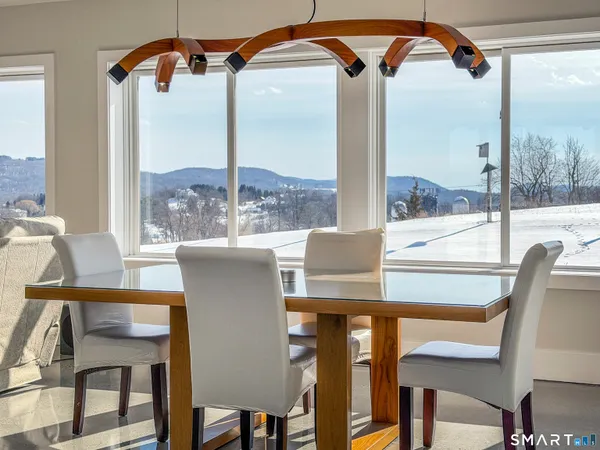 a view of a dining room with furniture and window
