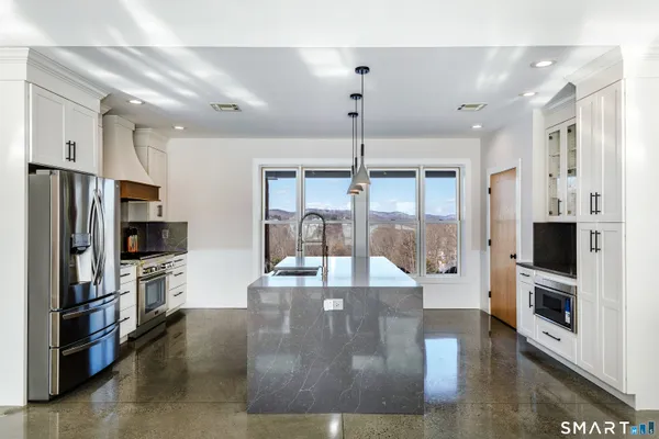 a view of a kitchen with refrigerator and microwave