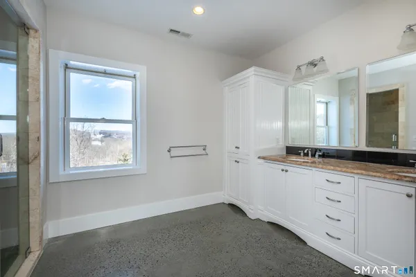 a bathroom with a double vanity sink and a mirror