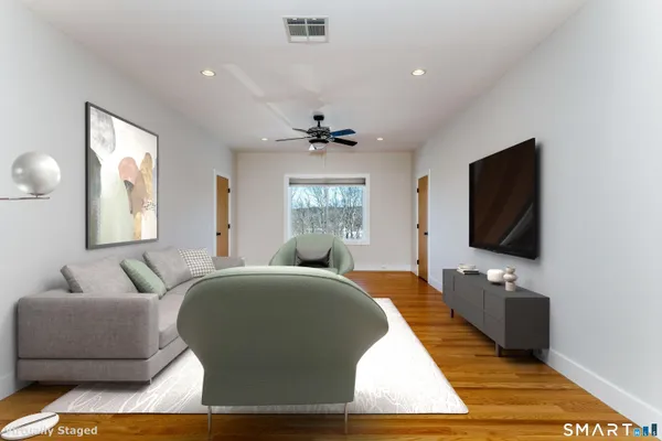 a living room with a flat screen tv and a window