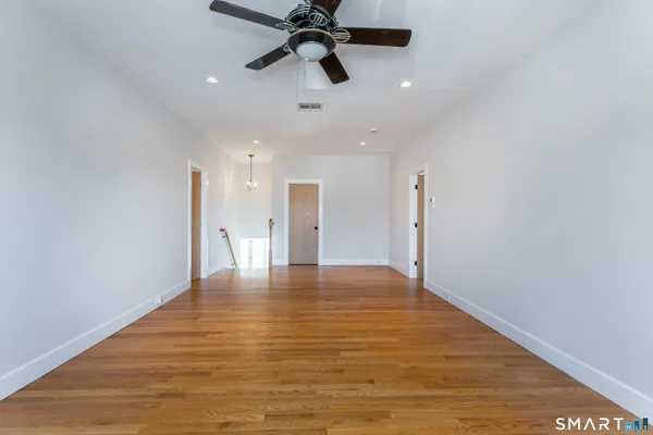 a view of an empty room with a ceiling fan