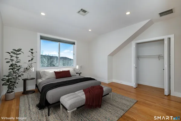 a bedroom with a bed and a window
