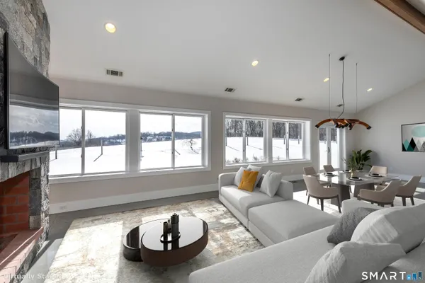 a living room with furniture and a flat screen tv