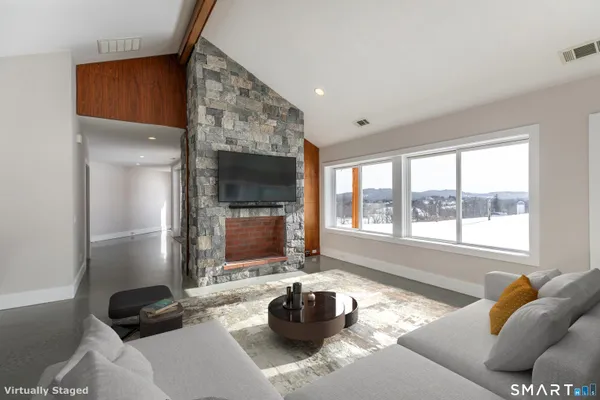 a living room with furniture and a flat screen tv