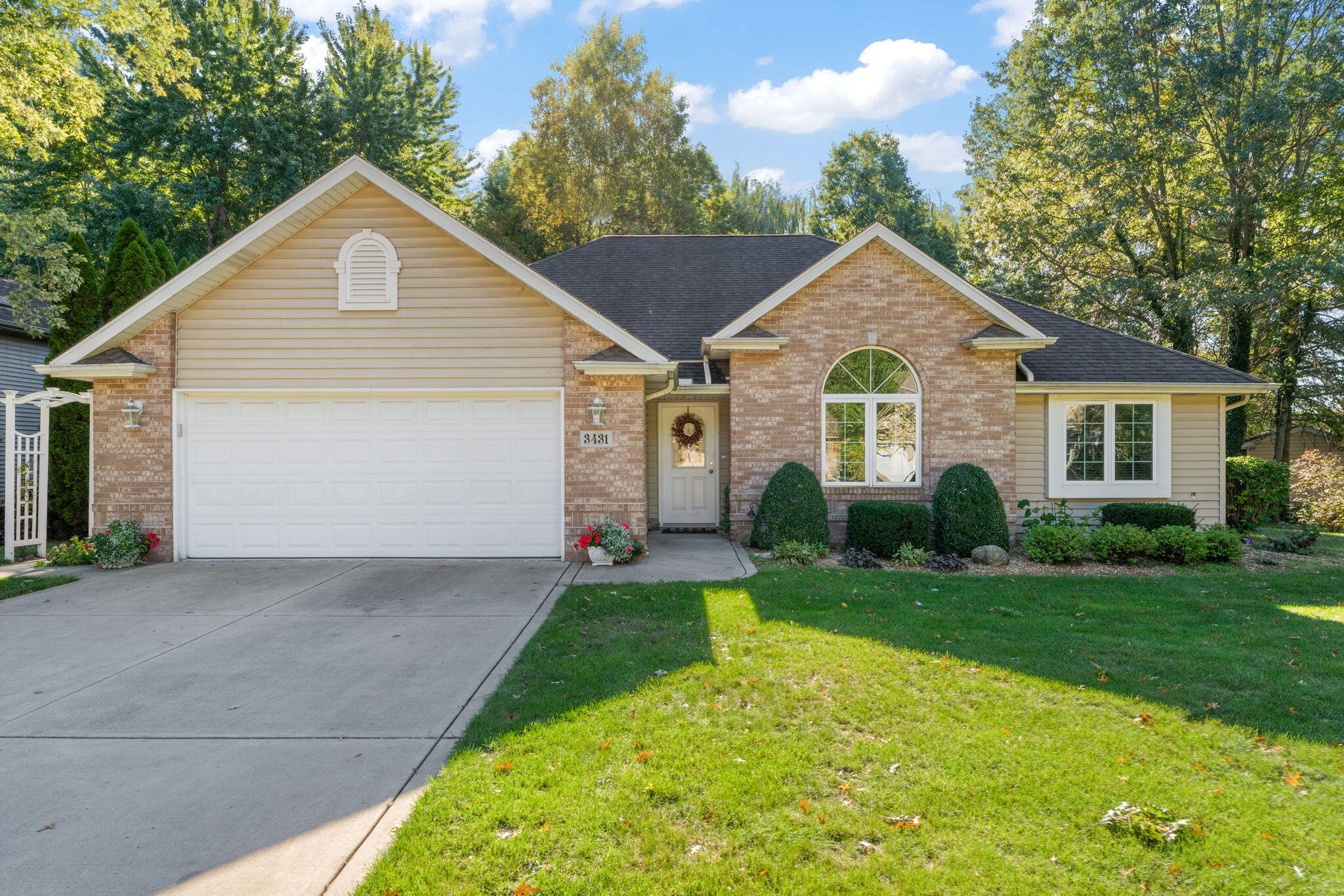 a front view of a house with a yard and garage