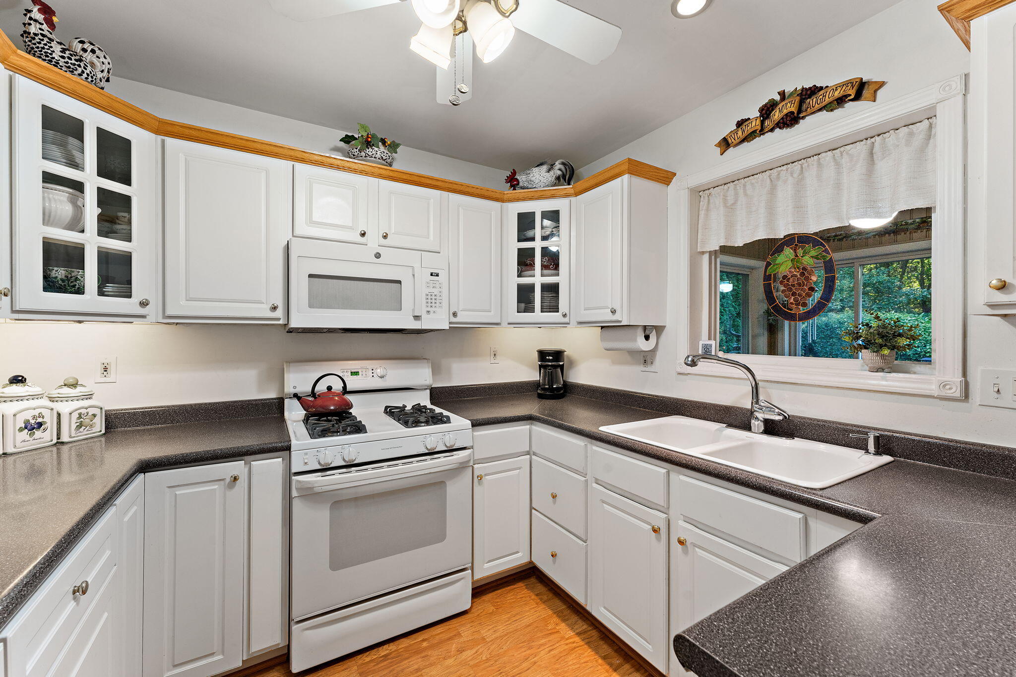 3431 Drivers Way Chesterton, IN 46304 - Photo 8 of 31 a kitchen with stainless steel appliances granite countertop a sink dishwasher a stove and white cabinets with wooden floor