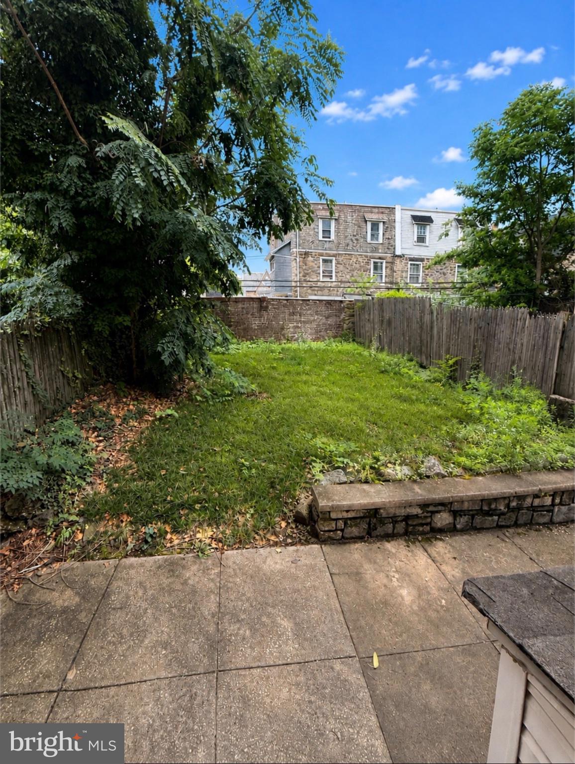 822 Wynnewood Road, Unit 1 Philadelphia, PA 19151 - Photo 16 of 16 a view of a backyard with plants and large trees