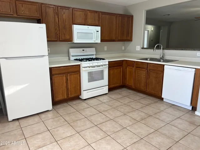 a kitchen with a sink a stove and a refrigerator