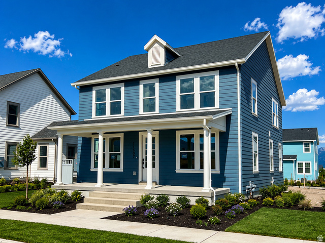 11507 Markfield Way, Unit 1124 South Jordan, UT 84009 - Photo 1 of 6 Two-story residence featuring blue horizontal siding, white trim, and a covered front porch with white columns
