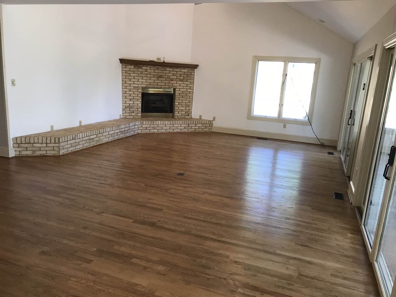 15 Lilly Farm Lane Raphine, VA 24472 - Photo 8 of 49 an empty room with wooden floor and fireplace