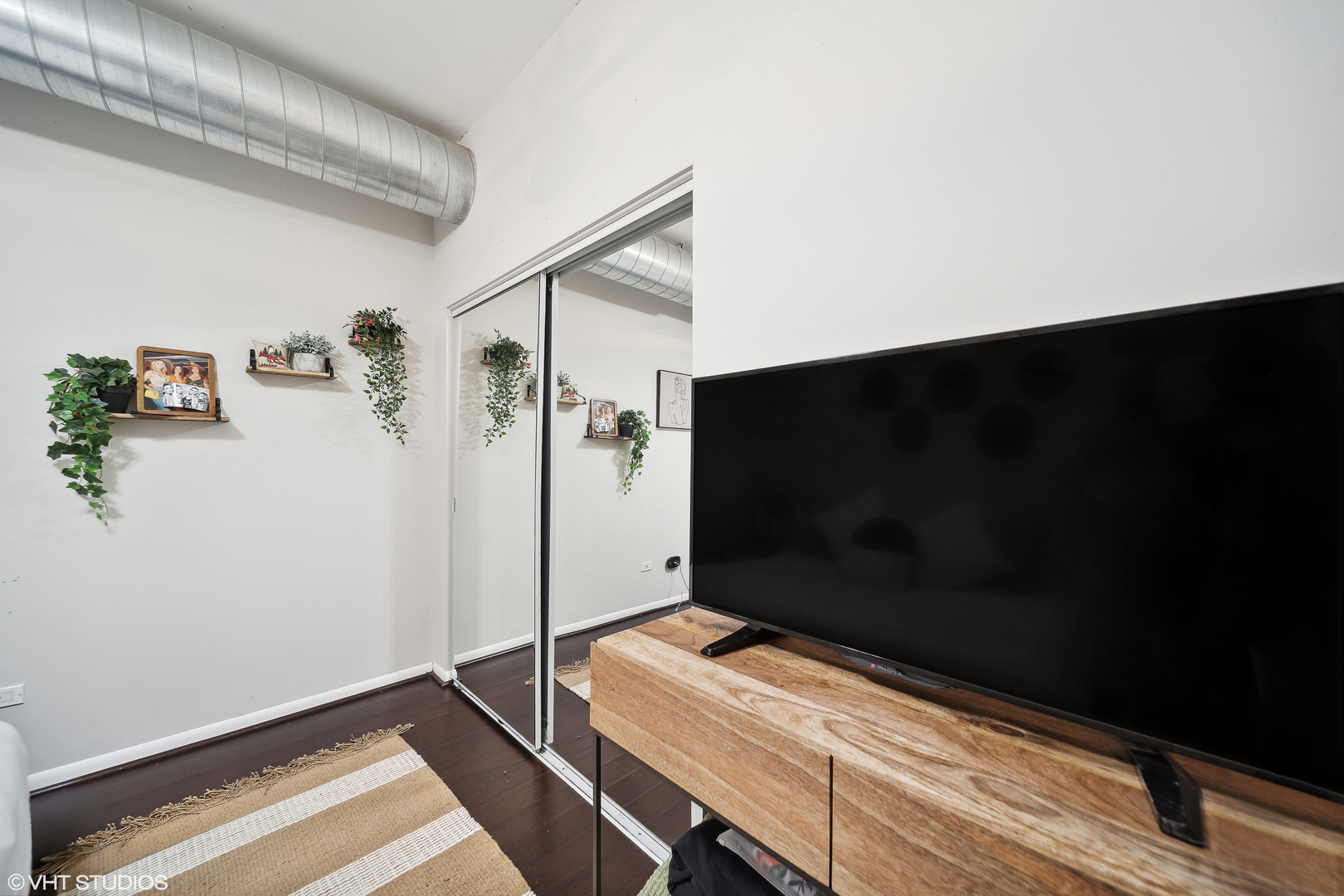 1200 West Monroe Street, Unit 418 Chicago, IL 60607 - Photo 11 of 17 a room with gym equipment and a flat screen tv