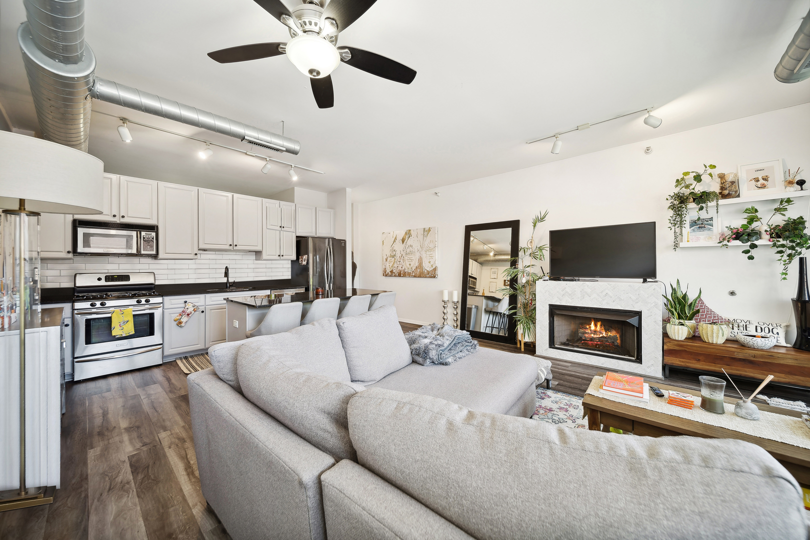 1200 West Monroe Street, Unit 418 Chicago, IL 60607 - Photo 4 of 17 a living room with stainless steel appliances furniture fireplace and flat screen tv