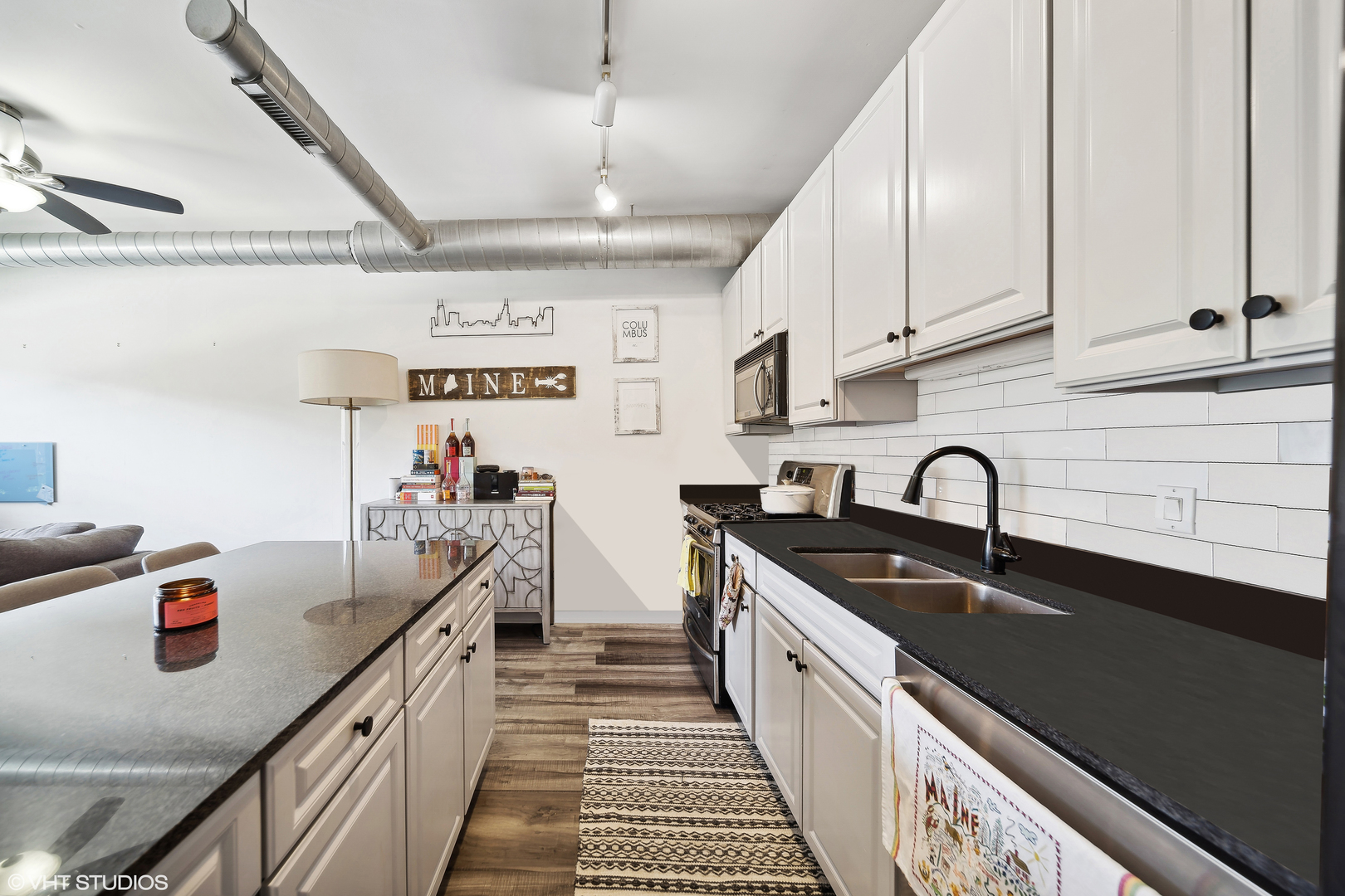 1200 West Monroe Street, Unit 418 Chicago, IL 60607 - Photo 9 of 17 a kitchen with stainless steel appliances a sink dishwasher a stove a refrigerator and cabinets with wooden floor