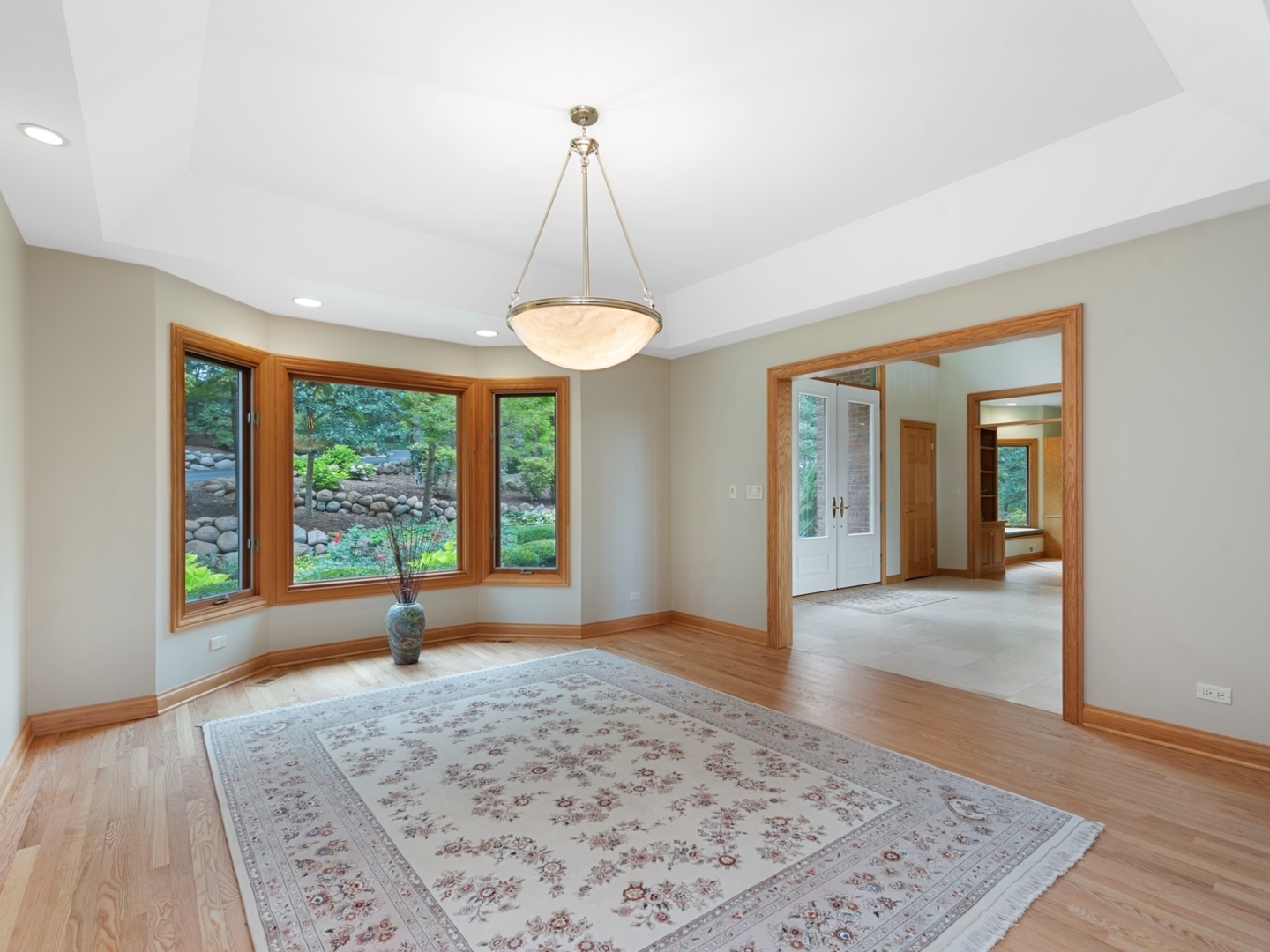 33 Brinker Road Barrington Hills, IL 60010 - Photo 7 of 43 a view of a livingroom with a chandelier and wooden floor