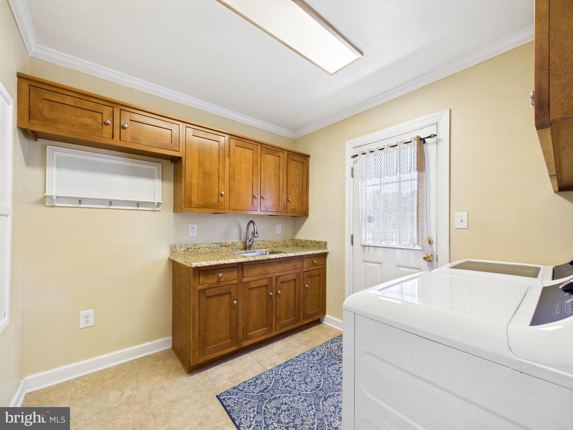 3298 Canterbury Road Milford, DE 19963 - Photo 39 of 74 Laundry Room with Sink and Cabinets