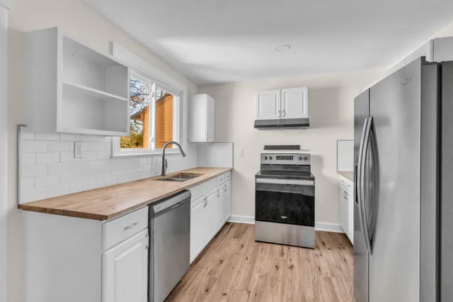 a kitchen with a sink stove and refrigerator