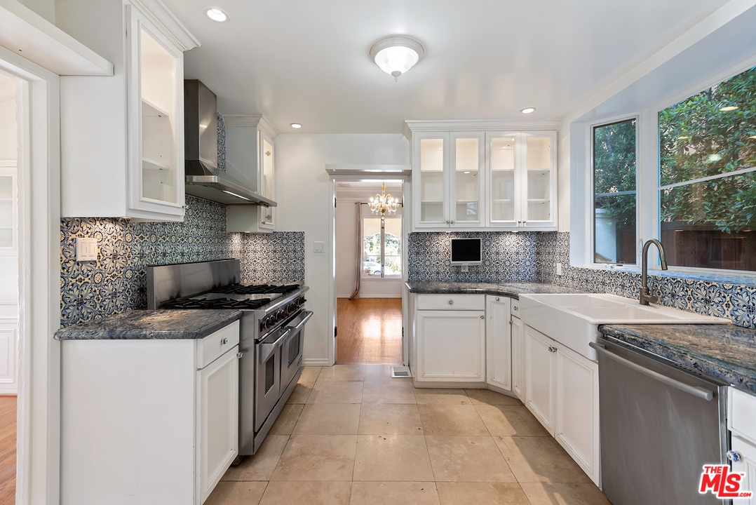 357 South La Peer Drive Beverly Hills, CA 90211 - Photo 11 of 31 a kitchen with a stove sink and cabinets
