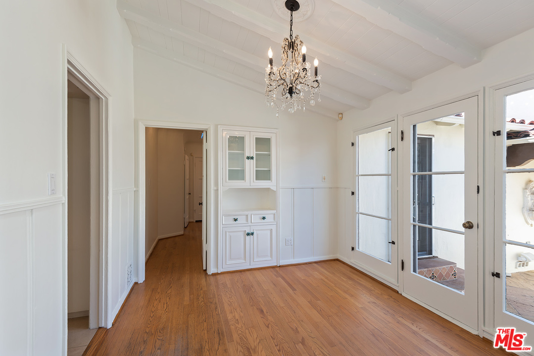357 South La Peer Drive Beverly Hills, CA 90211 - Photo 13 of 31 a view of a hallway with wooden floor and chandelier