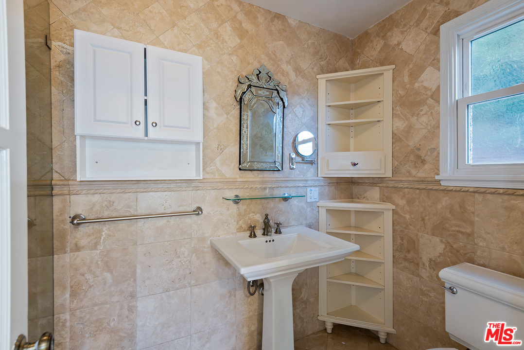 357 South La Peer Drive Beverly Hills, CA 90211 - Photo 16 of 31 a bathroom with a sink toilet and vanity