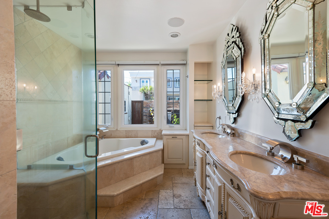 357 South La Peer Drive Beverly Hills, CA 90211 - Photo 17 of 31 a bathroom with a granite countertop double vanity sink a mirror and a bathtub